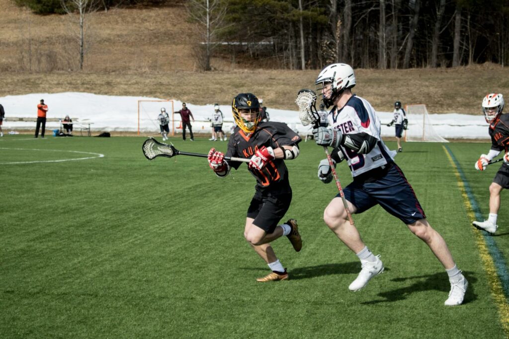 male lacrosse players playing on the field