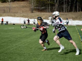 male lacrosse players playing on the field