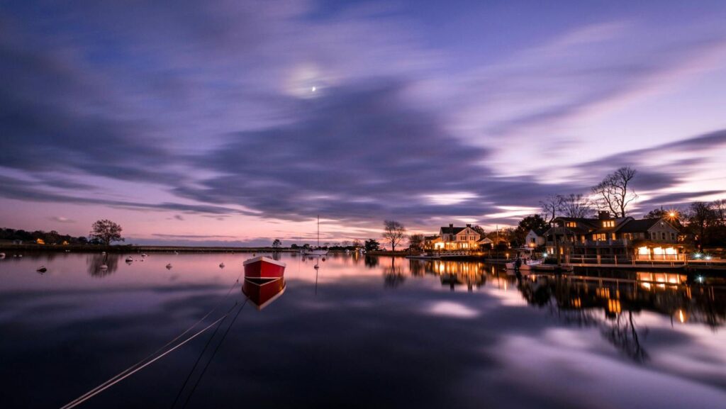 A waterfront in Fairfield, CT, visible from the water at dusk.